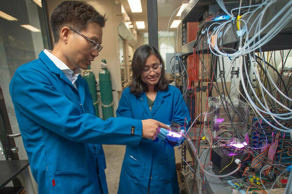 Nosang Myung, the Bernard Keating-Crawford Professor of Engineering at the University of Notre Dame, works with graduate student, Suporna Paul, in Myung’s lab in McCourtney Hall. (Photo by Wes Evard/University of Notre Dame)